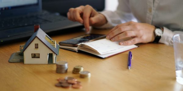 Closeup shot of a person thinking of buying or selling a house